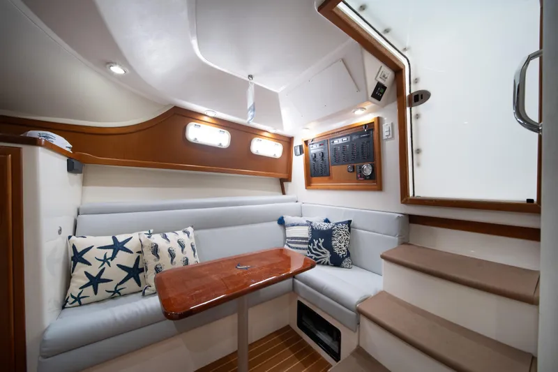 Slide: The Image of Luxurious 2004 Cabo 35 Express yacht interior with cozy seating and nautical decor. - 27