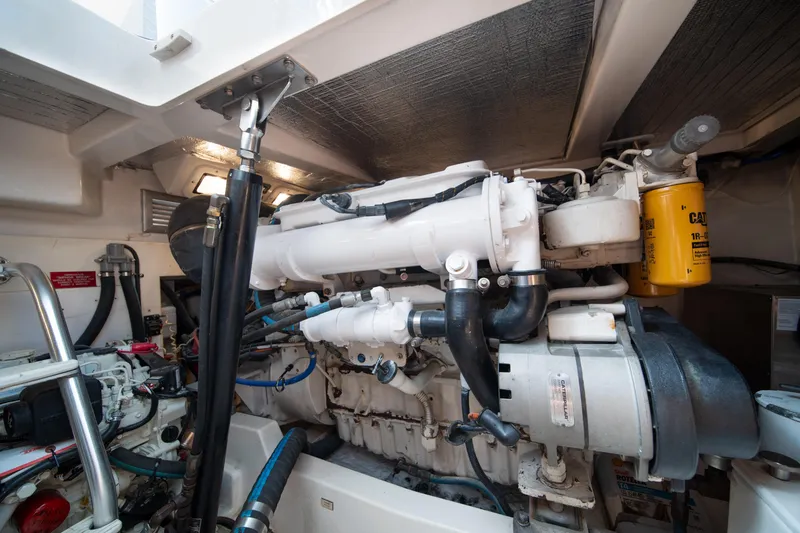 Slide: The Image of Engine room of a 2004 Cabo 35 Express boat, showcasing detailed machinery and components. - 33
