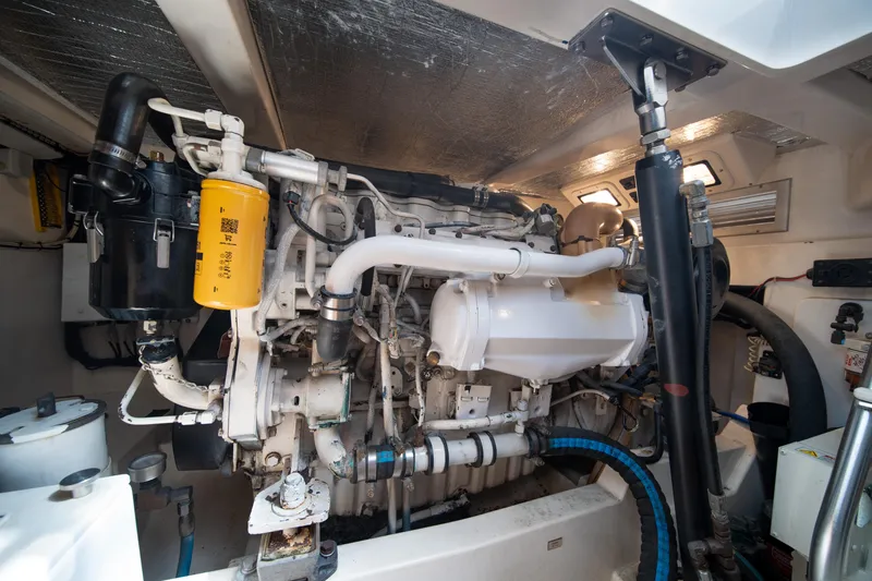 Slide: The Image of Engine room of a 2004 Cabo 35 Express boat, showcasing detailed machinery and components. - 34