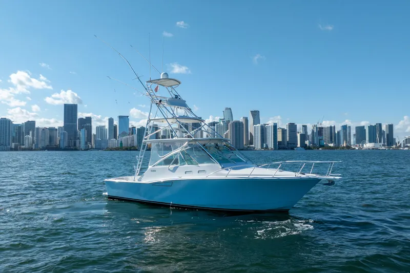 Slide: The Image of 2004 Cabo 35 Express boat on water with city skyline background. - 5