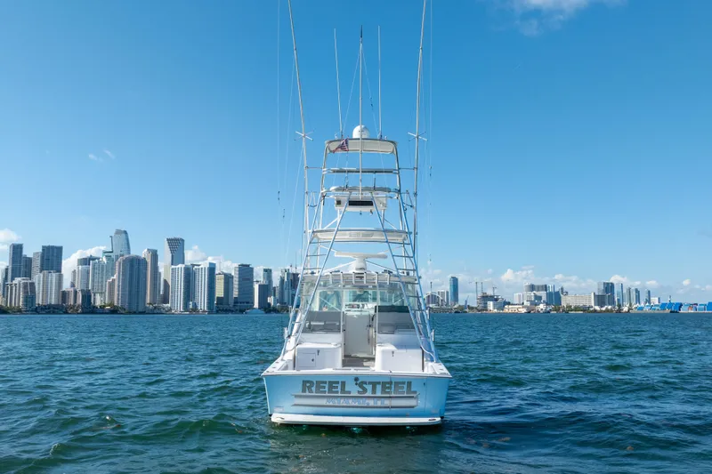 Slide: The Image of Cabo 35 Express 2004 boat on water with city skyline in background. - 8