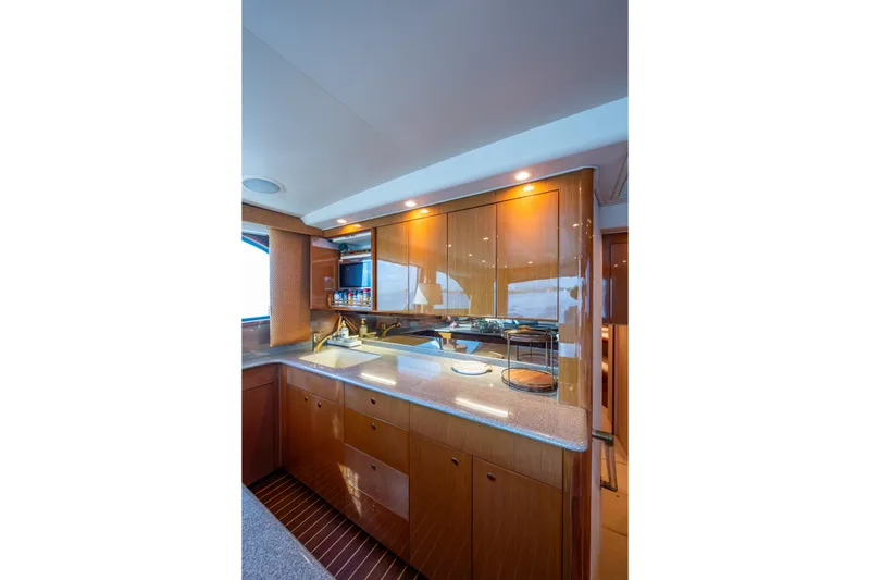 Slide: The Image of Luxurious kitchen interior of 2004 Viking 48 Convertible yacht with wooden cabinetry. - 11