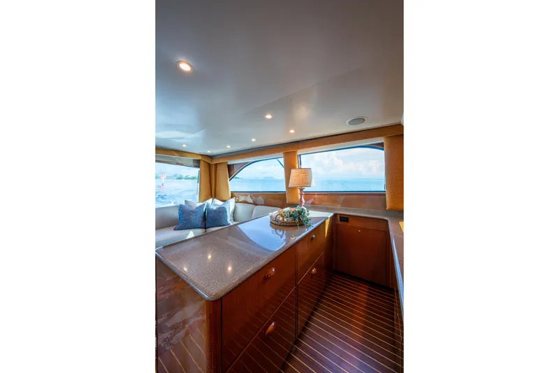 Slide: The Image of Luxurious interior of 2004 Viking 48 Convertible yacht with elegant wood finishes and ocean view. - 12