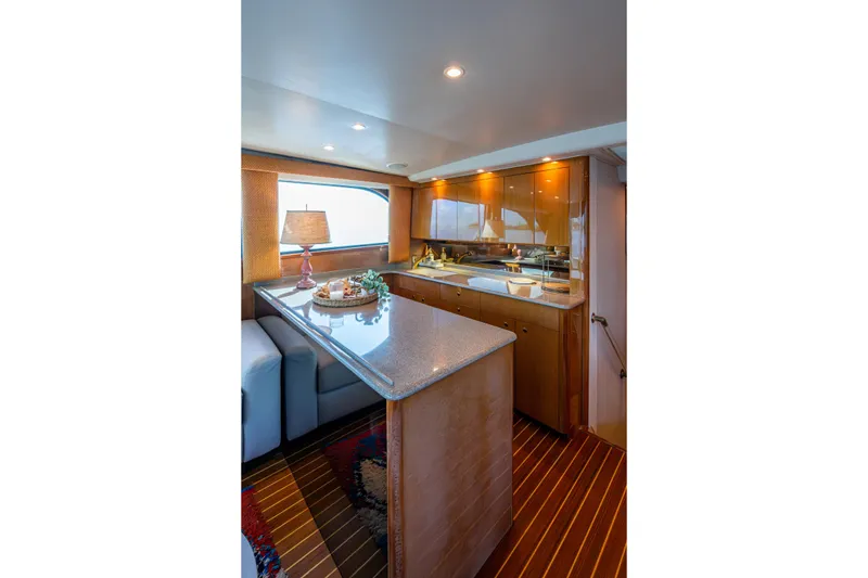 Slide: The Image of Luxurious interior of 2004 Viking 48 Convertible yacht with elegant kitchen and seating area. - 13