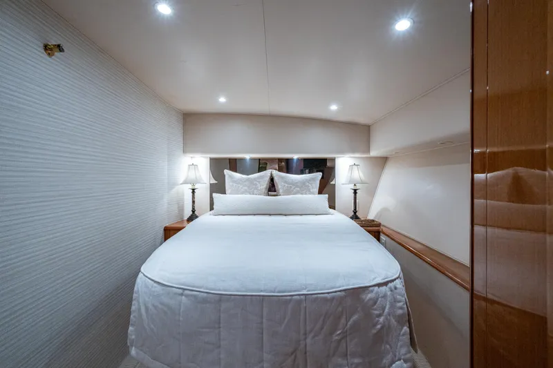 Slide: The Image of Luxurious bedroom interior of 2004 Viking 48 Convertible yacht with elegant bedding and lighting. - 14