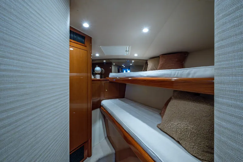 Slide: The Image of Interior of 2004 Viking 48 Convertible yacht with cozy bunk beds and wooden cabinetry. - 18