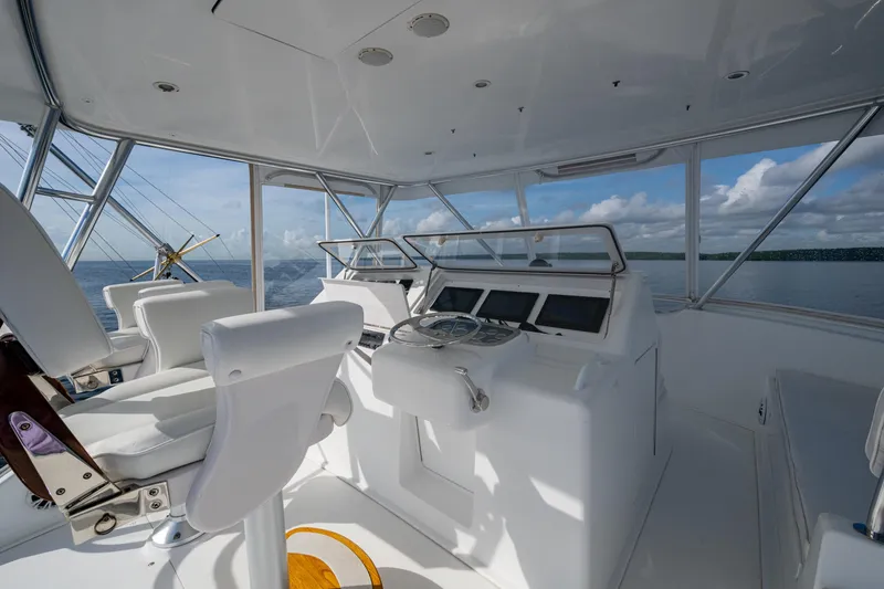 Slide: The Image of 2004 Viking 48 Convertible yacht helm with ocean view and modern controls. - 29