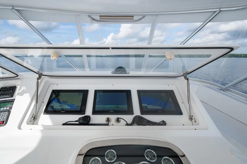 Slide: The Image of Control panel of a 2004 Viking 48 Convertible yacht with navigation screens and ocean view. - 31