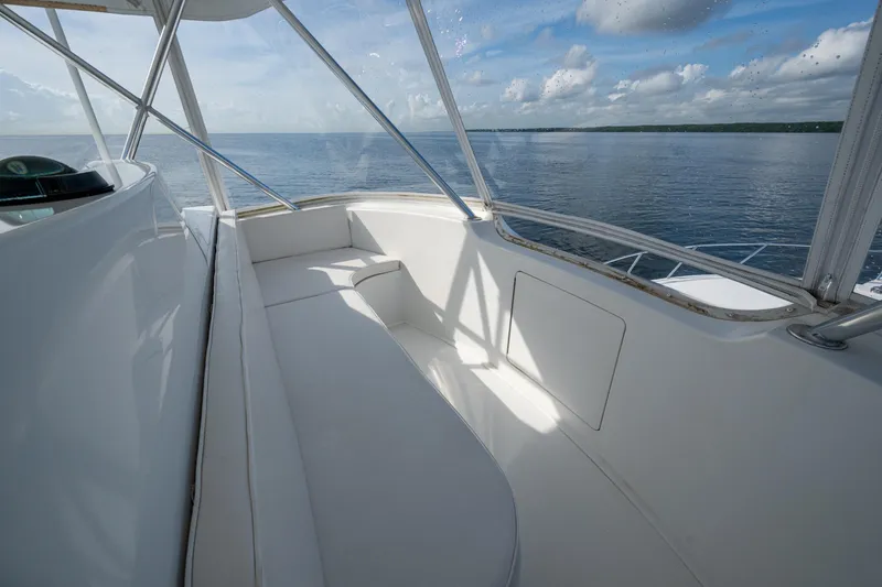 Slide: The Image of 2004 Viking 48 Convertible yacht interior with ocean view and white seating. - 32