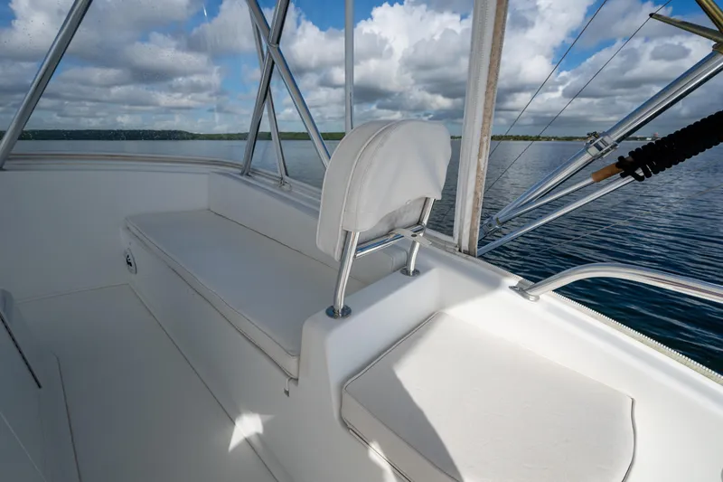 Slide: The Image of 2004 Viking 48 Convertible boat interior with white seating and ocean view. - 33