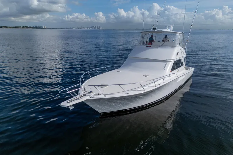 Slide: The Image of 2004 Viking 48 Convertible yacht cruising on calm ocean waters. - 43