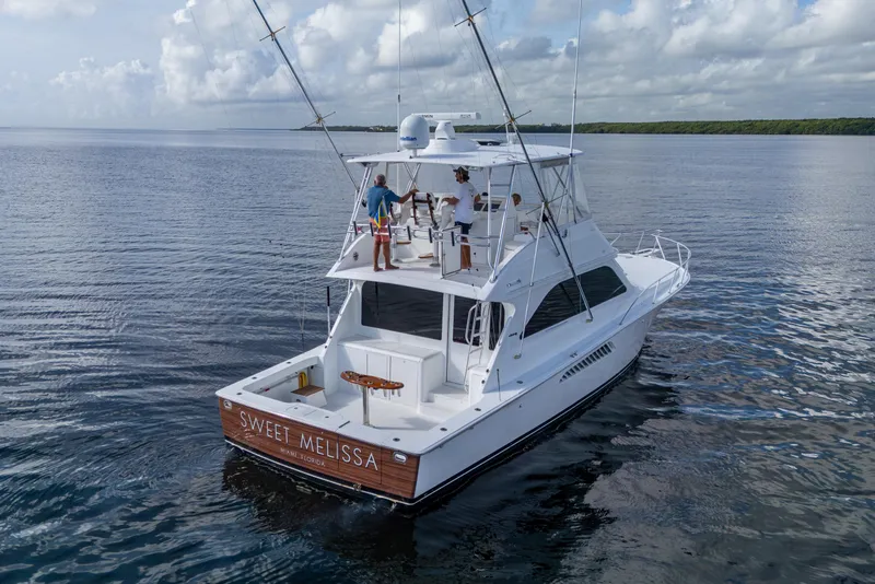 Slide: The Image of 2004 Viking 48 Convertible yacht "Sweet Melissa" cruising on calm waters. - 45