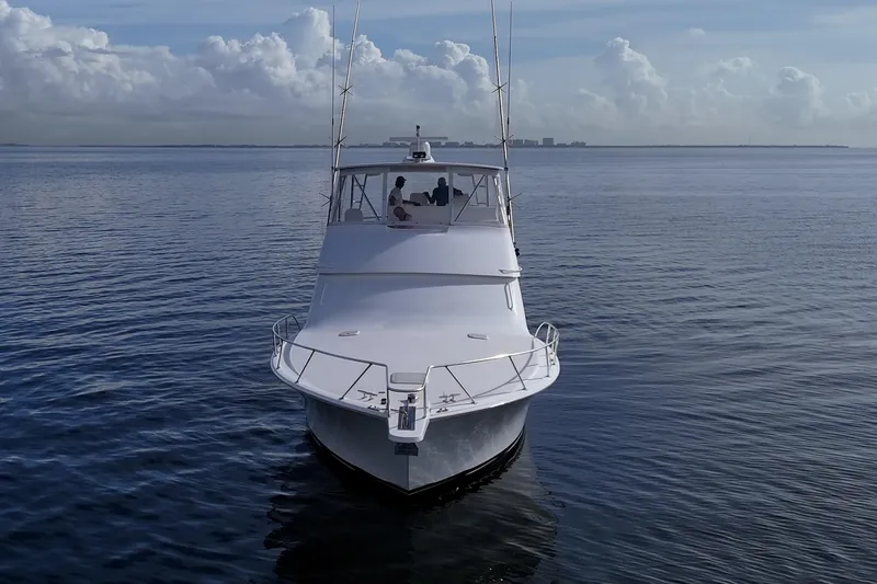 Slide: The Image of 2004 Viking 48 Convertible yacht cruising on calm ocean waters. - 47