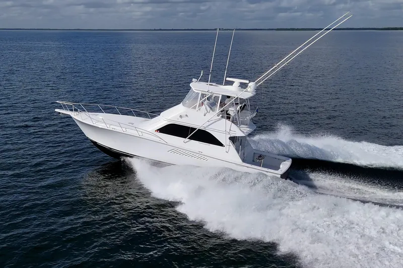 Slide: The Image of 2004 Viking 48 Convertible yacht cruising swiftly on open water. - 51