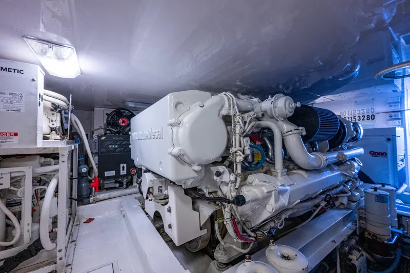 Slide: The Image of Engine room of 2004 Viking 48 Convertible yacht, showcasing marine diesel engine. - 56