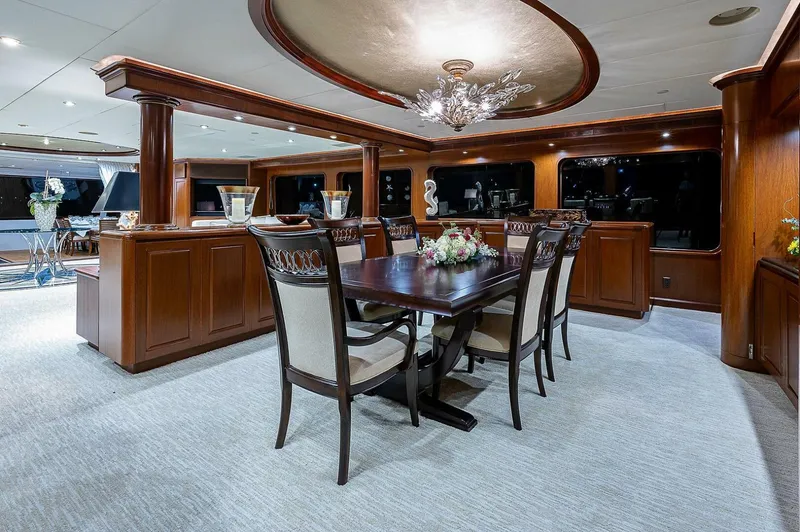 Slide: The Image of Luxurious dining area on a 2000 Christensen 141 Raised Pilothouse yacht with elegant wood finishes. - 18