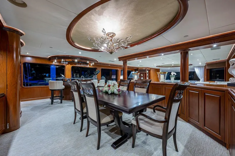 Slide: The Image of Luxurious dining area on 2000 Christensen 141 Raised Pilothouse yacht, elegant wood finishes. - 19