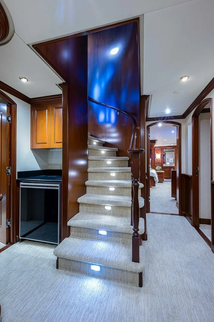 Slide: The Image of Luxurious interior of 2000 Christensen 141 Raised Pilothouse yacht with elegant staircase. - 21