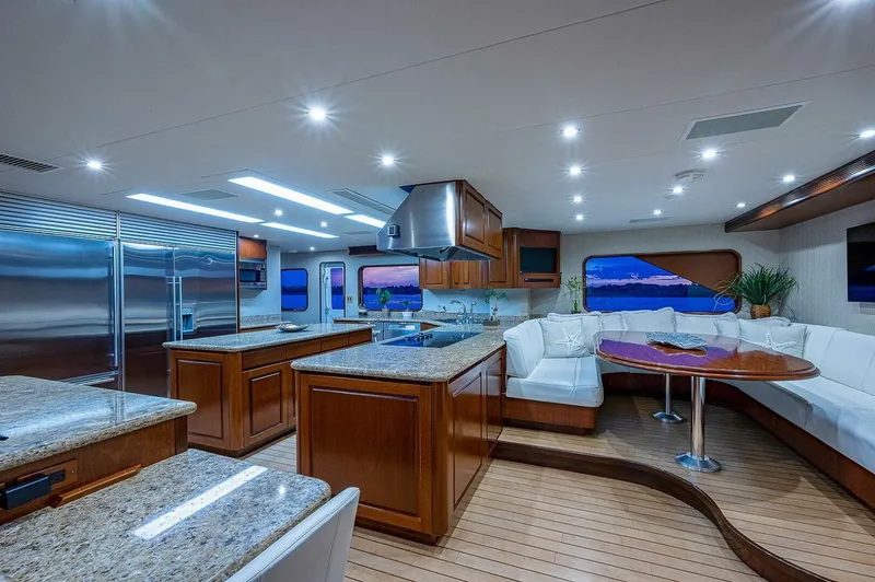 Slide: The Image of Luxurious interior of 2000 Christensen 141 Raised Pilothouse yacht with modern kitchen and seating area. - 24