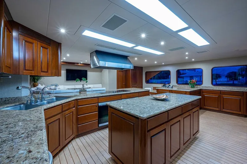 Slide: The Image of Luxurious kitchen interior on 2000 Christensen 141 Raised Pilothouse yacht with wooden cabinetry. - 25