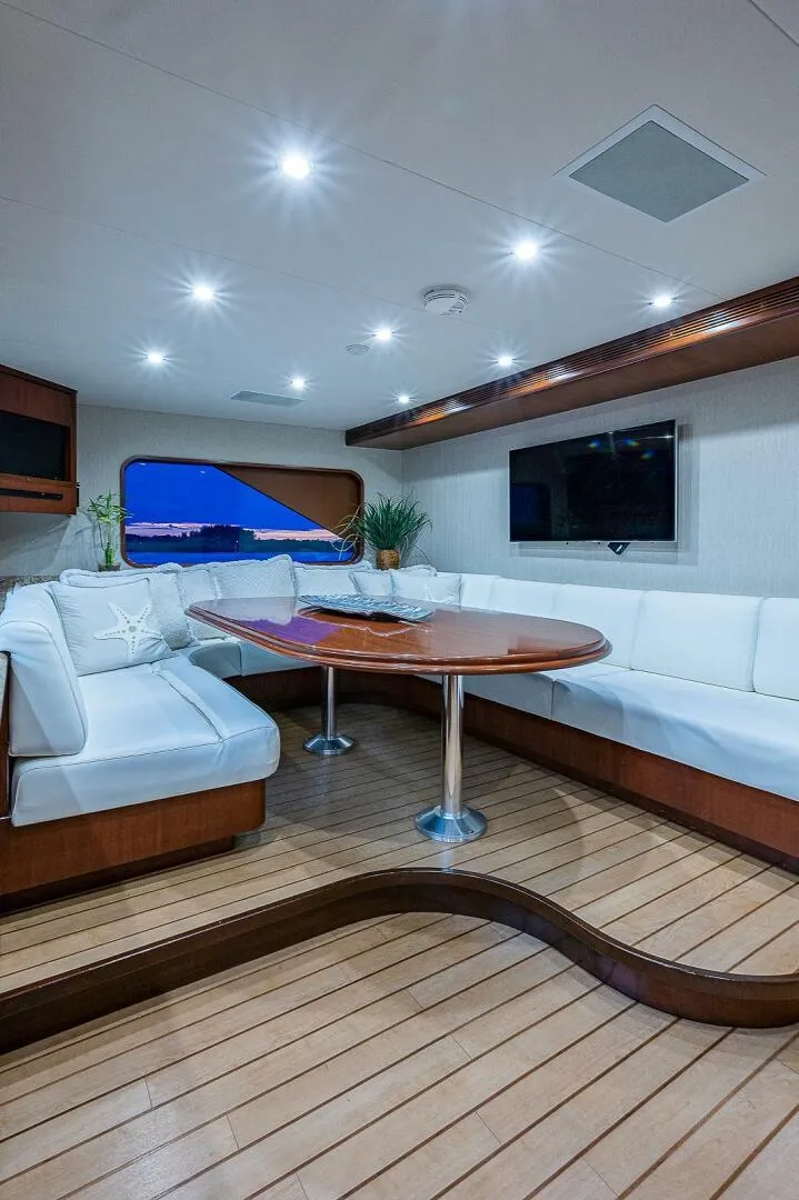 Slide: The Image of Luxurious interior of 2000 Christensen 141 Raised Pilothouse yacht with elegant seating and wooden flooring. - 27