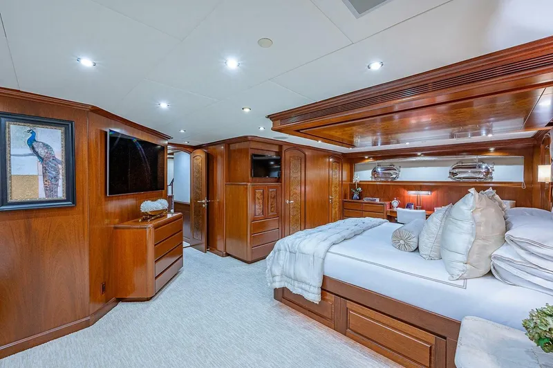 Slide: The Image of Luxurious bedroom interior of 2000 Christensen 141 Raised Pilothouse yacht with elegant wood finishes. - 3