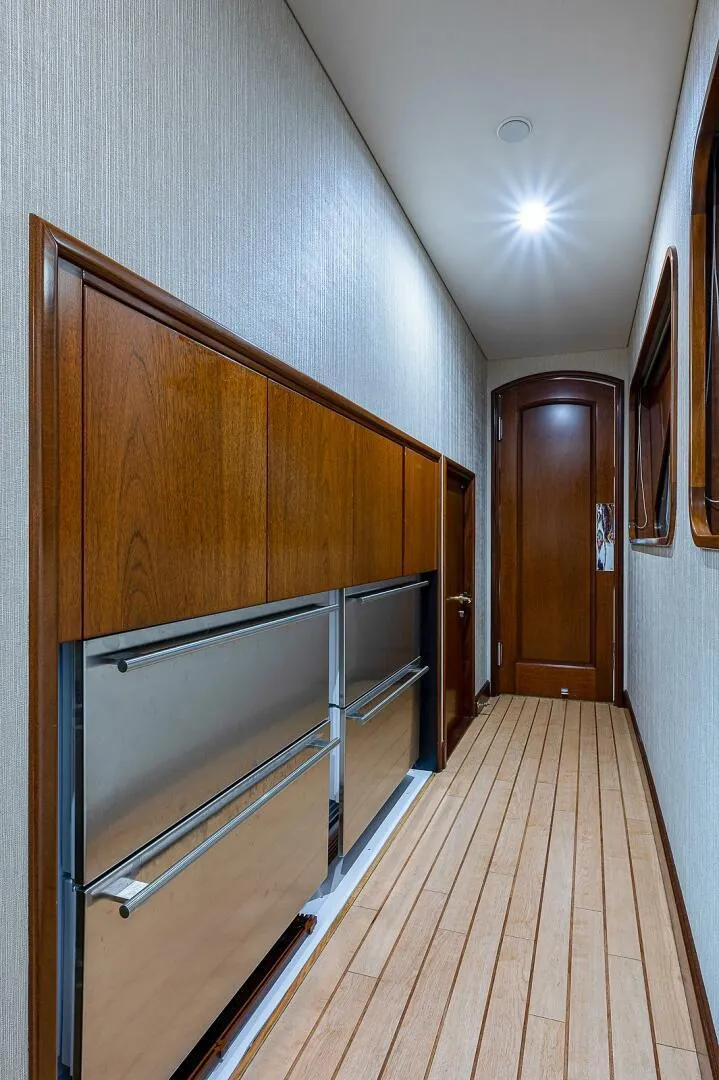 Slide: The Image of Luxurious hallway in 2000 Christensen 141 Raised Pilothouse yacht with wood paneling and modern lighting. - 30
