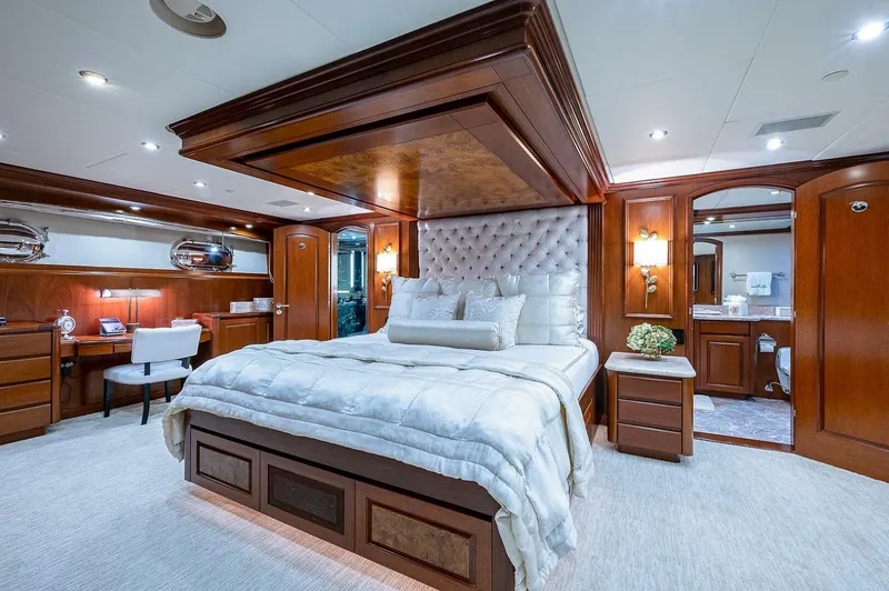 Slide: The Image of Luxurious bedroom on Christensen 141 Raised Pilothouse yacht, featuring elegant wood paneling and plush bedding. - 32