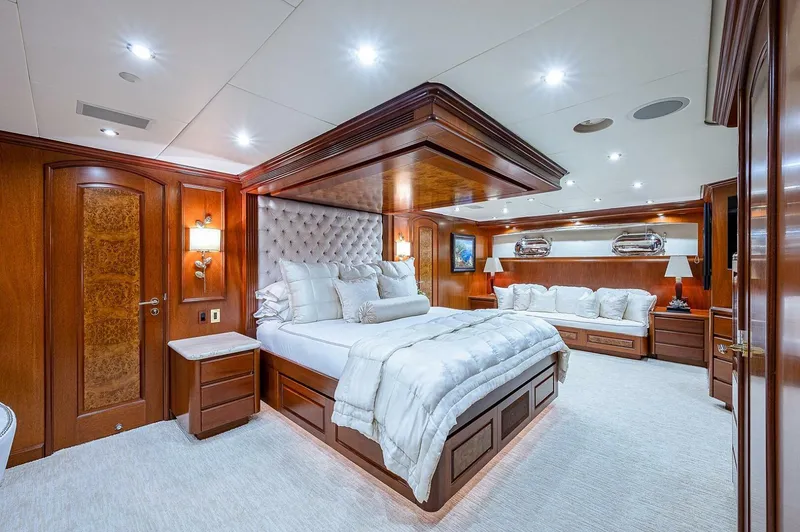 Slide: The Image of Luxurious bedroom interior on 2000 Christensen 141 Raised Pilothouse yacht, featuring elegant wood finishes. - 33