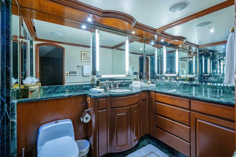Slide: The Image of Luxurious bathroom with wood cabinetry and marble countertops on a 2000 Christensen 141 Raised Pilothouse yacht. - 36