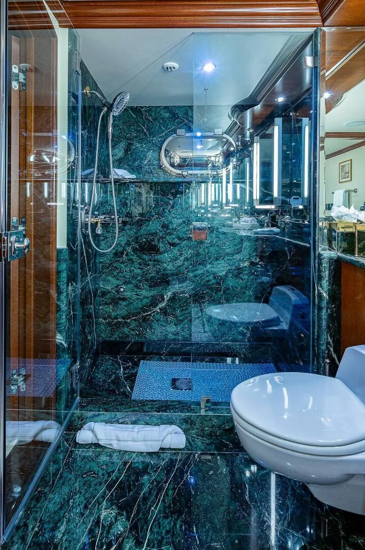 Slide: The Image of Luxurious yacht bathroom with green marble, glass shower, and modern fixtures on Christensen 141 Raised Pilothouse. - 37