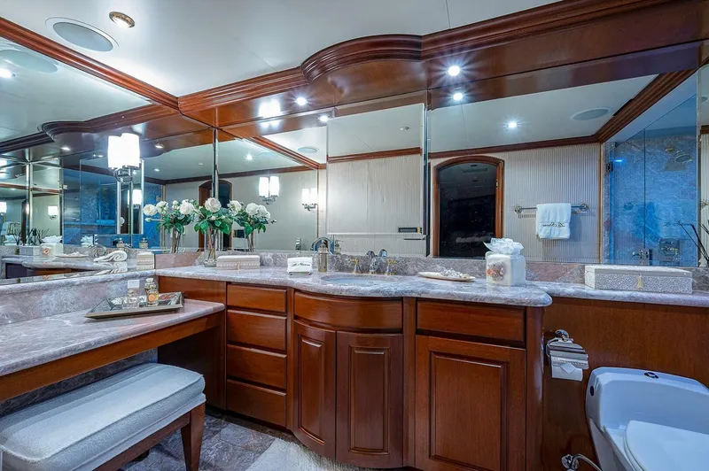 Slide: The Image of Luxurious yacht bathroom with wooden cabinetry, marble countertops, and elegant lighting on Christensen 141 Raised Pilothouse. - 38