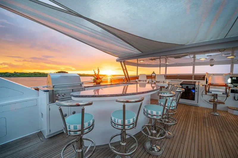Slide: The Image of Luxurious yacht deck with bar seating, sunset view; Christensen 141 Raised Pilothouse, 2000 model. - 4