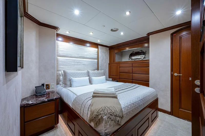 Slide: The Image of Luxurious bedroom interior on 2000 Christensen 141 Raised Pilothouse yacht, featuring elegant wood finishes. - 41