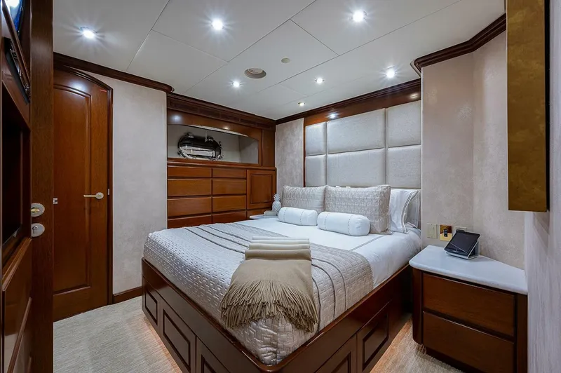 Slide: The Image of Luxurious bedroom interior on 2000 Christensen 141 Raised Pilothouse yacht, featuring elegant wood finishes. - 45