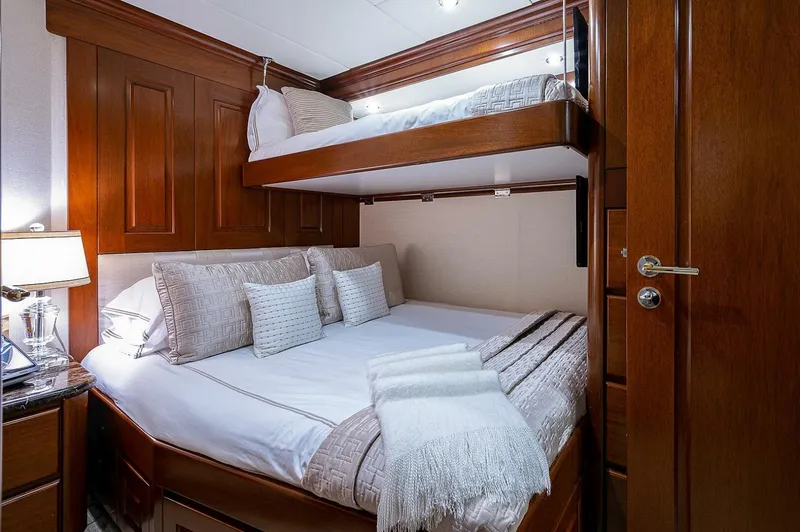 Slide: The Image of Luxurious cabin interior with wooden paneling and cozy bedding on Christensen 141 Raised Pilothouse yacht. - 49