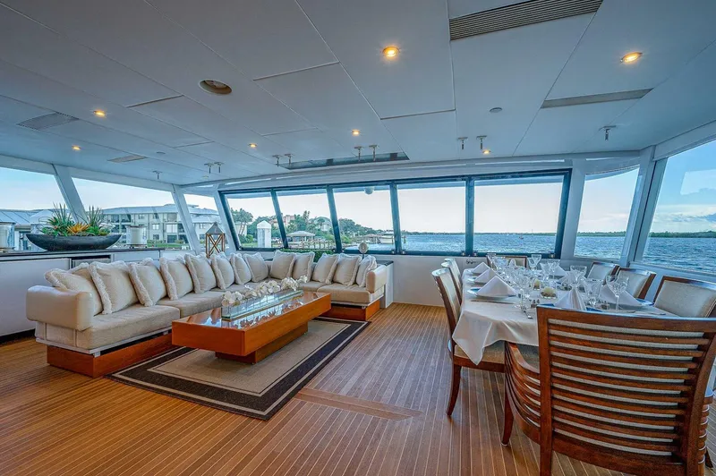 Slide: The Image of Luxurious interior of 2000 Christensen 141 Raised Pilothouse yacht with elegant seating and dining area. - 9