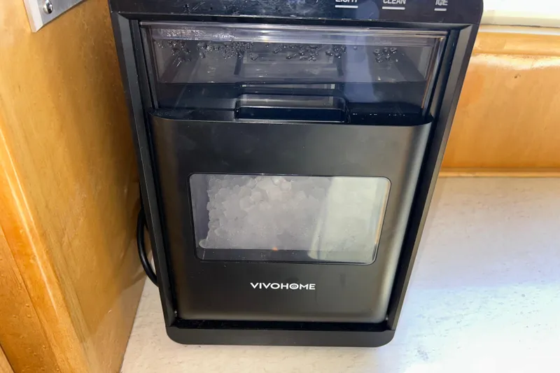 Slide: The Image of VIVOHOME ice maker on Navigator 53 Classic yacht, 1999 model, in a wooden interior setting. - 14