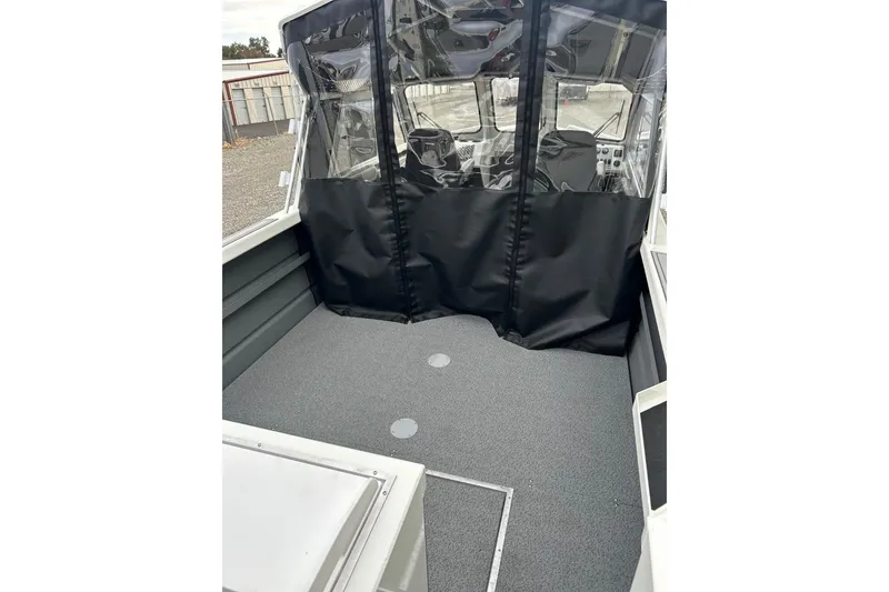 Slide: The Image of 2026 Thunder Jet 22 Chinook OS boat interior with covered cockpit area. - 15