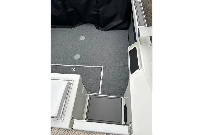 Slide: The Image of 2026 Thunder Jet 22 Chinook OS boat interior with gray flooring and storage compartments. - 17