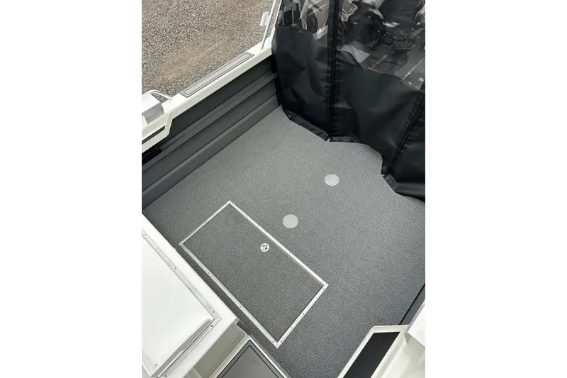 Slide: The Image of Interior view of 2026 Thunder Jet 22 Chinook OS boat with carpeted flooring. - 18