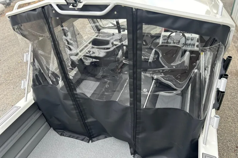 Slide: The Image of 2026 Thunder Jet 22 Chinook OS boat interior with protective cover and modern controls. - 19