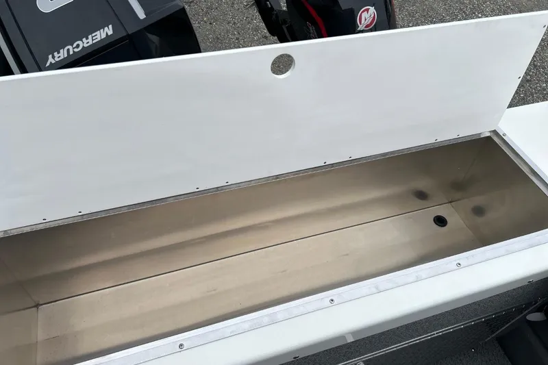 Slide: The Image of Open storage compartment in 2026 Thunder Jet 22 Chinook OS boat, featuring Mercury engine. - 21