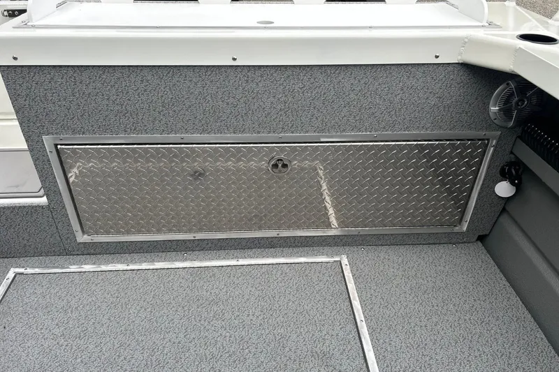 Slide: The Image of 2026 Thunder Jet 22 Chinook OS interior with diamond plate storage compartment. - 22