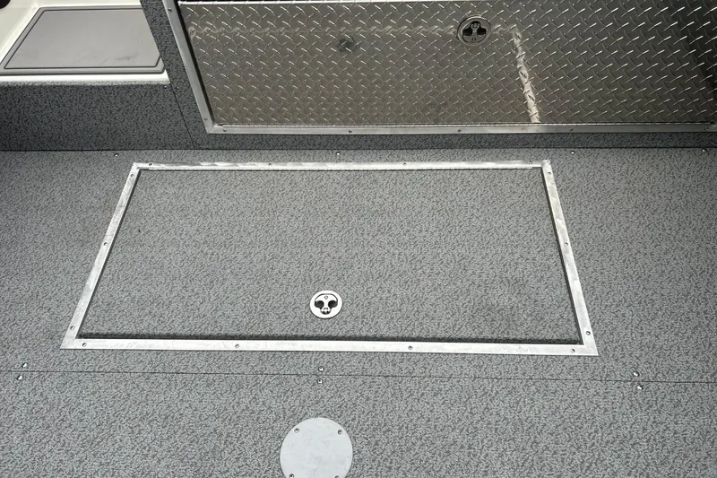 Slide: The Image of 2026 Thunder Jet 22 Chinook OS boat deck with storage hatch and diamond plate panel. - 23