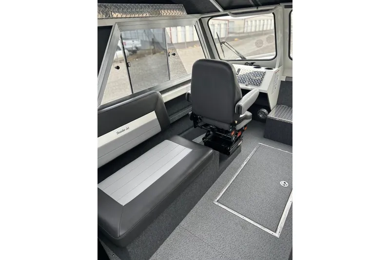 Slide: The Image of Interior of 2026 Thunder Jet 22 Chinook OS boat, featuring seating and helm area. - 27