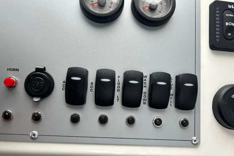 Slide: The Image of Control panel of 2026 Thunder Jet 22 Chinook OS boat with switches and gauges. - 33