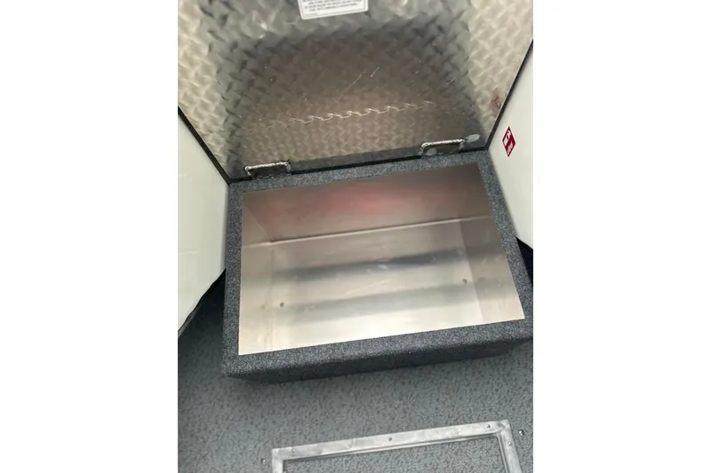Slide: The Image of Storage compartment in 2026 Thunder Jet 22 Chinook OS boat, featuring a diamond plate lid. - 39