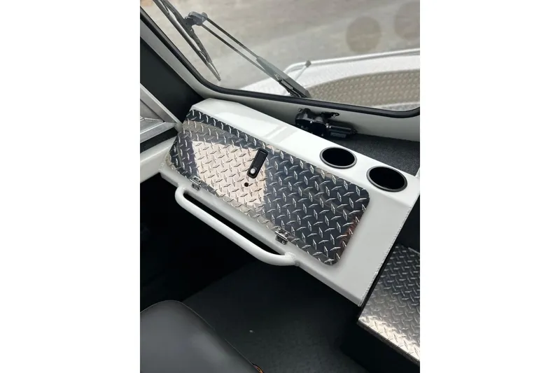 Slide: The Image of 2026 Thunder Jet 22 Chinook OS interior with diamond plate accents and cup holders. - 42