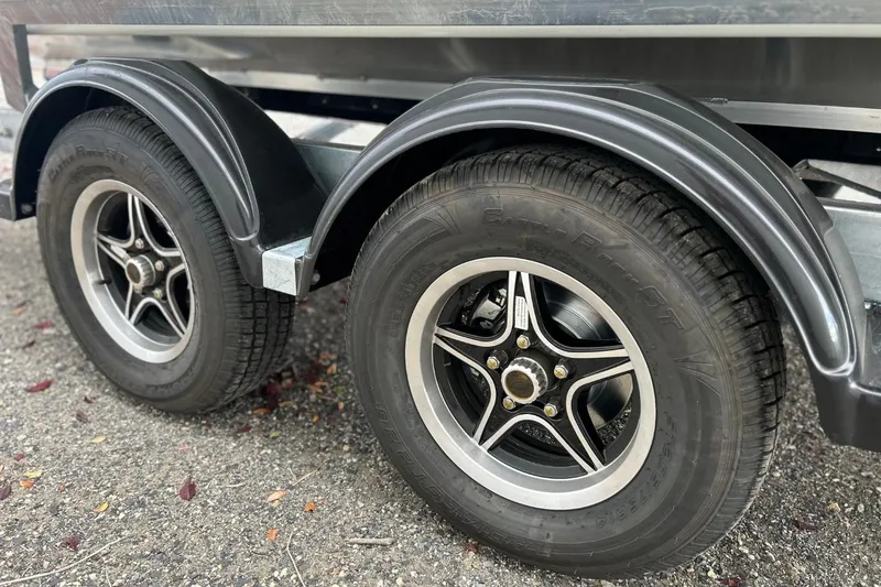 Slide: The Image of Trailer wheels of a 2026 Thunder Jet 22 Chinook OS on gravel surface. - 48